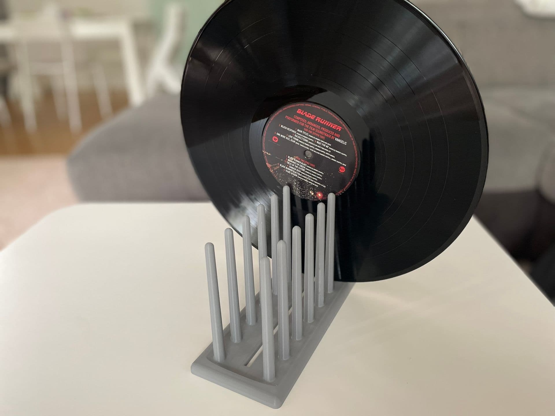 A freshly cleaned record standing on edge in a drying rack.