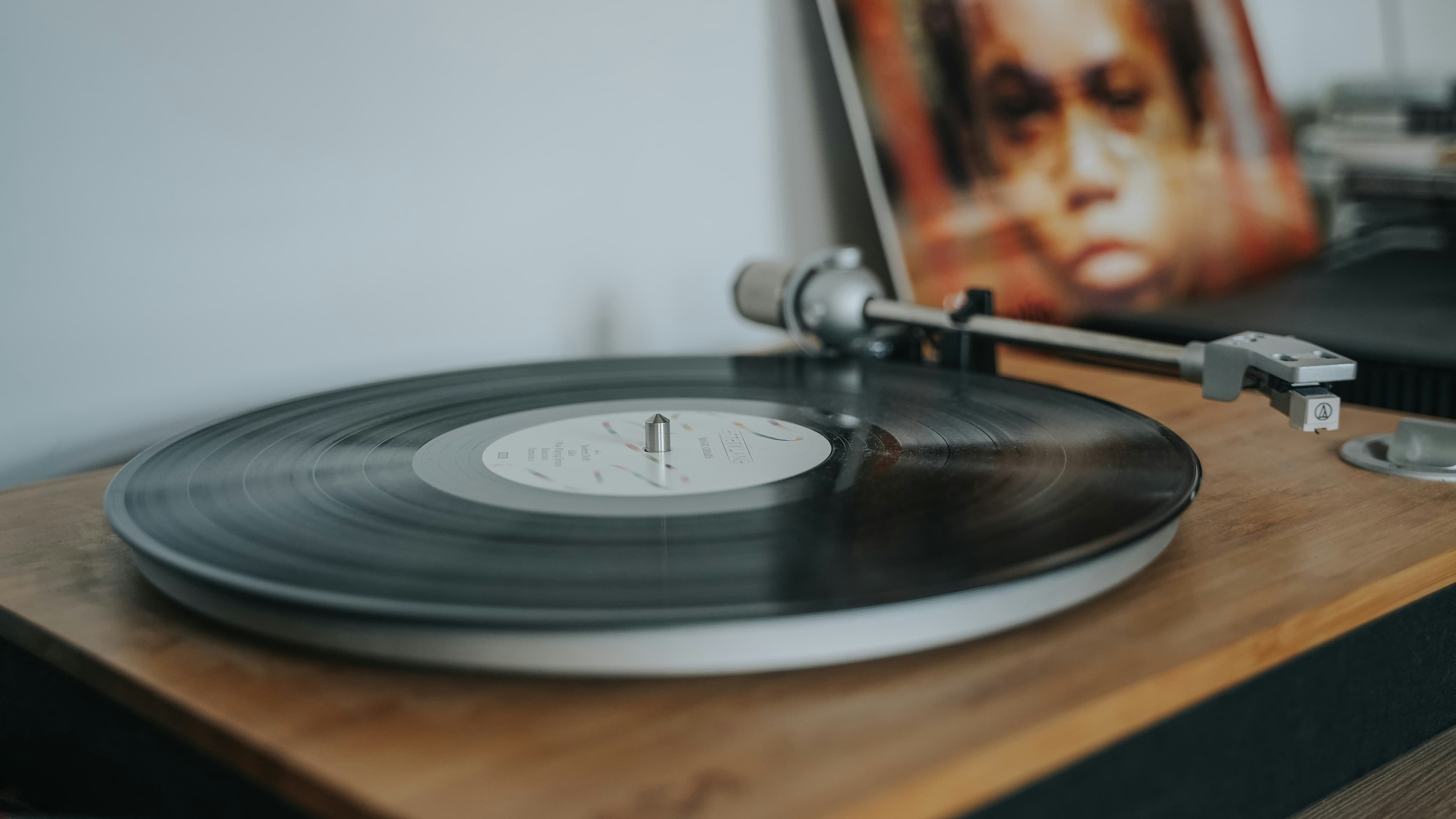 A beginner turntable setup: a turntable with a counterweighted tonearm, playing into a pair of speakers.